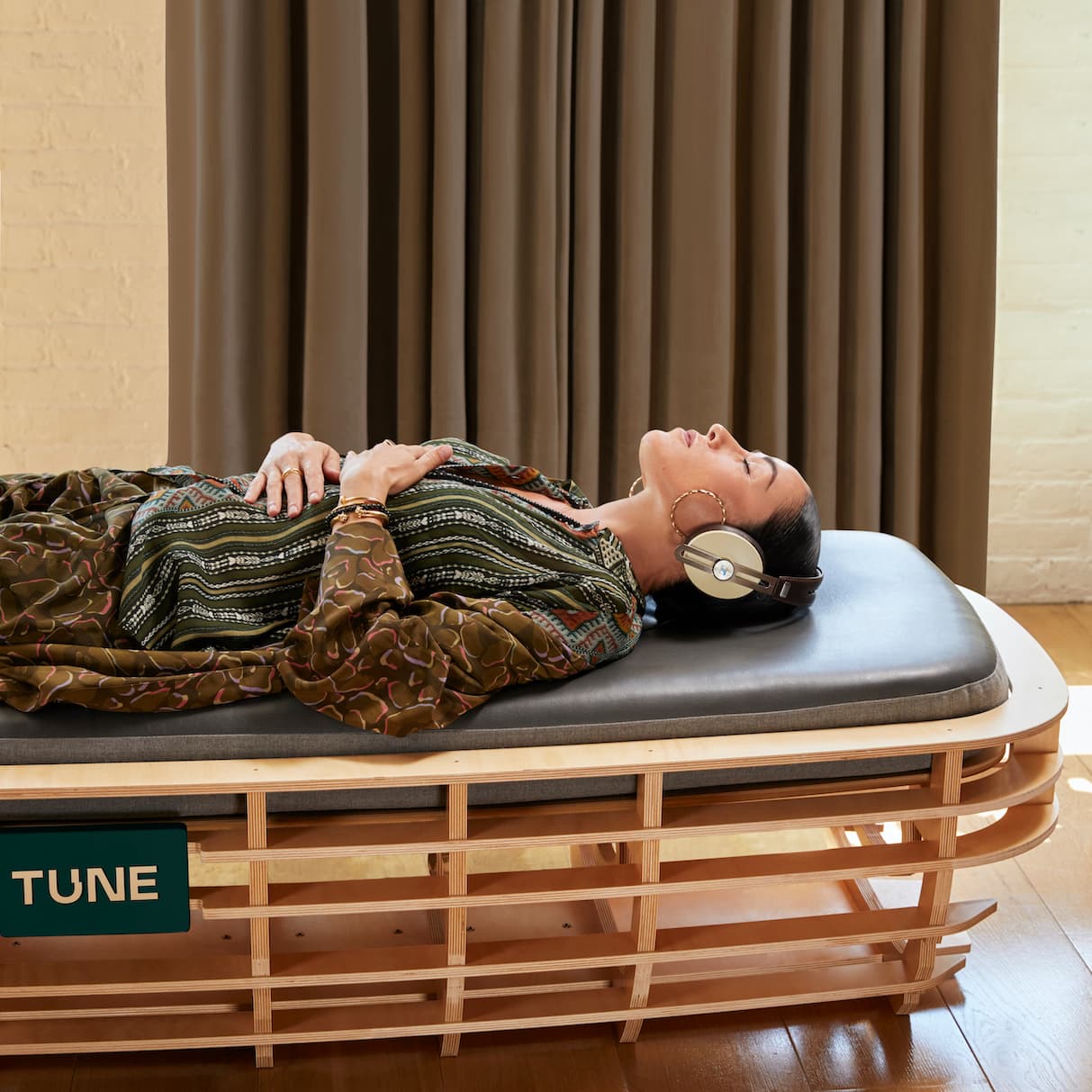 Woman laying on a TUNE bed